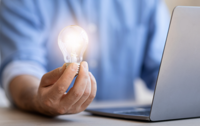 Businessman holding lightbulb