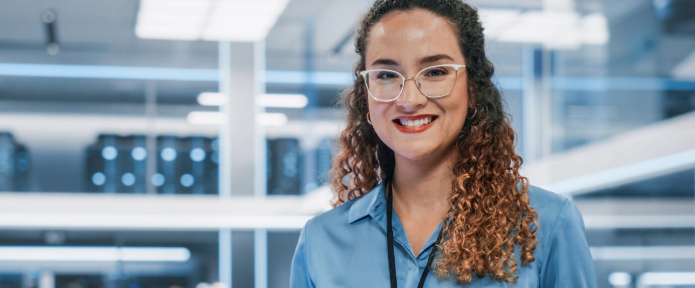 business professional wearing blue shirt and lanyard standing in lab