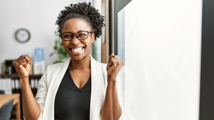 business office worker celebrating in light office