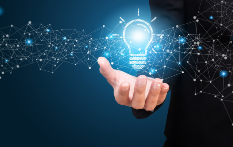 Innovation lightbulb floating above an employees hand