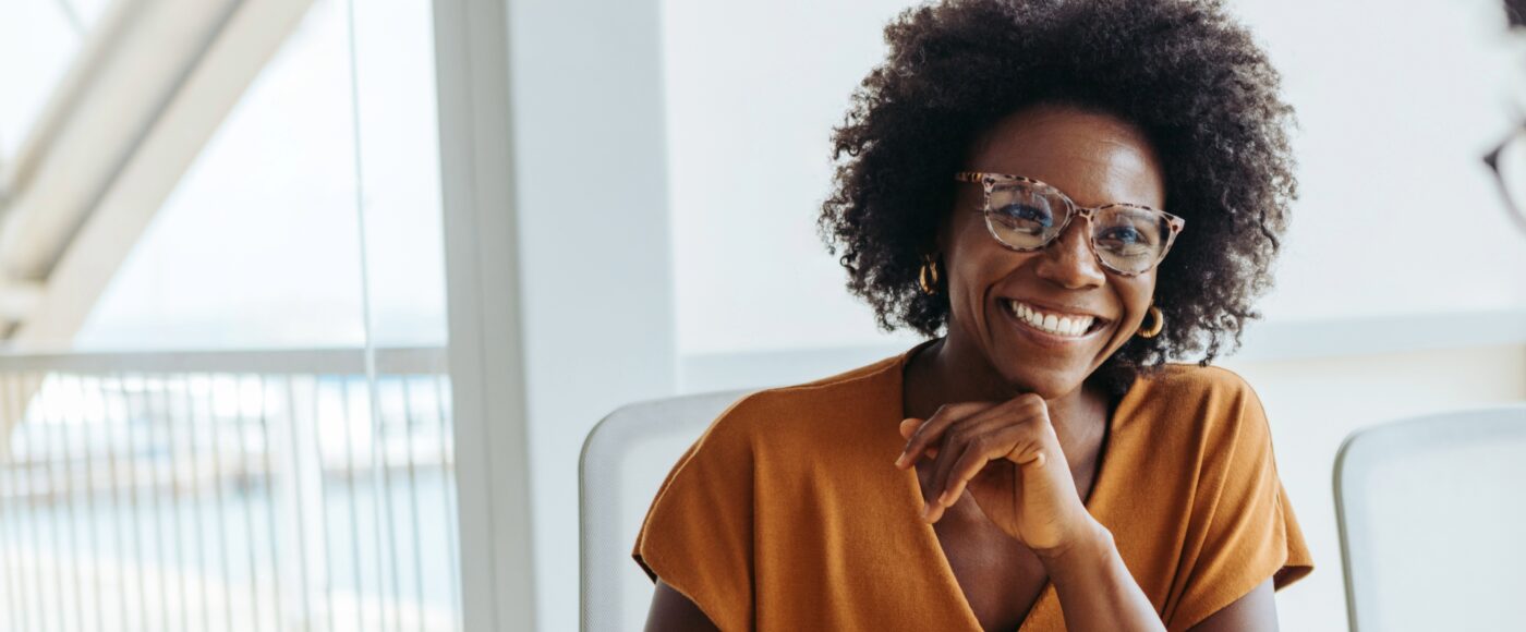 Smiling professional in meeting with window behind