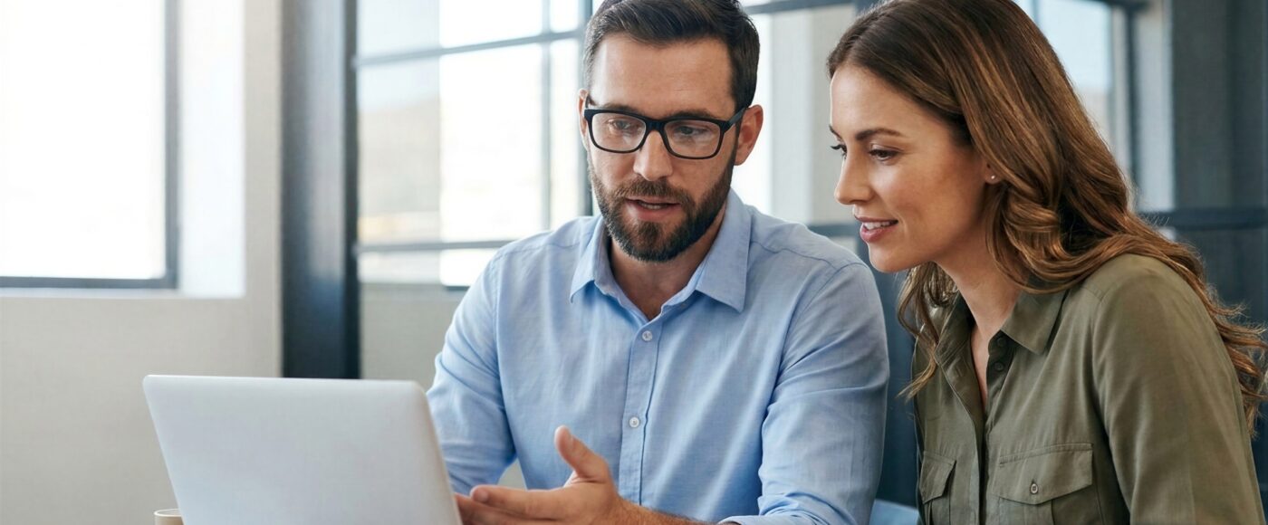 two office workers using AI on laptop to complete project