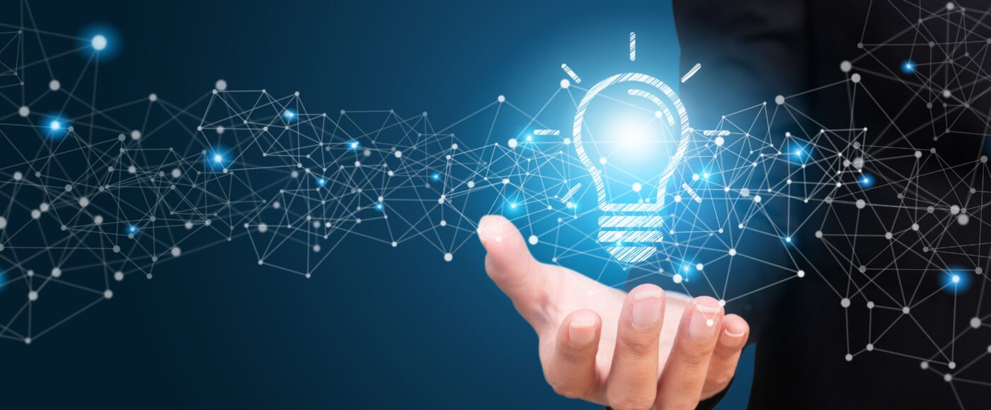 Innovation lightbulb floating above an employees hand