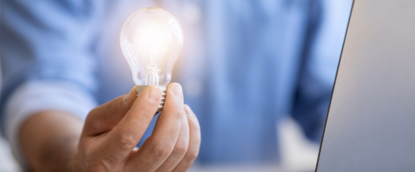 Businessman holding lightbulb