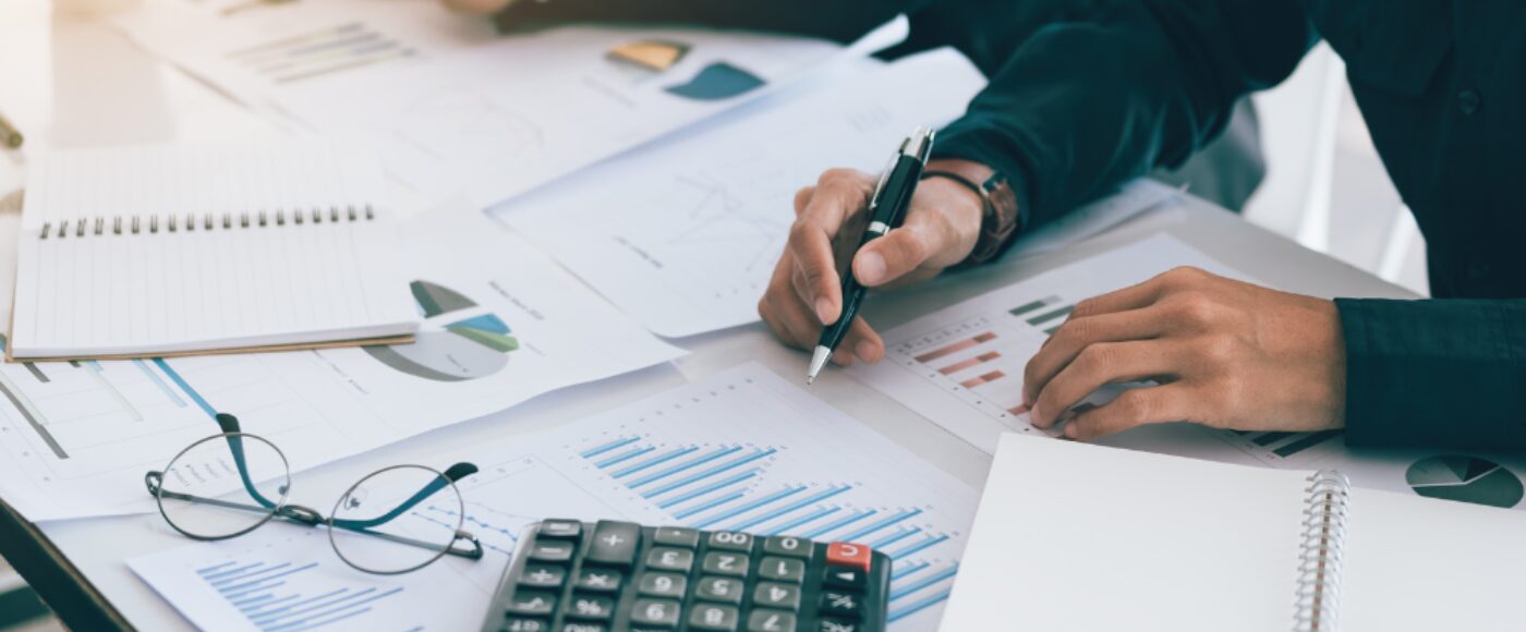 Two Business People calculating charts