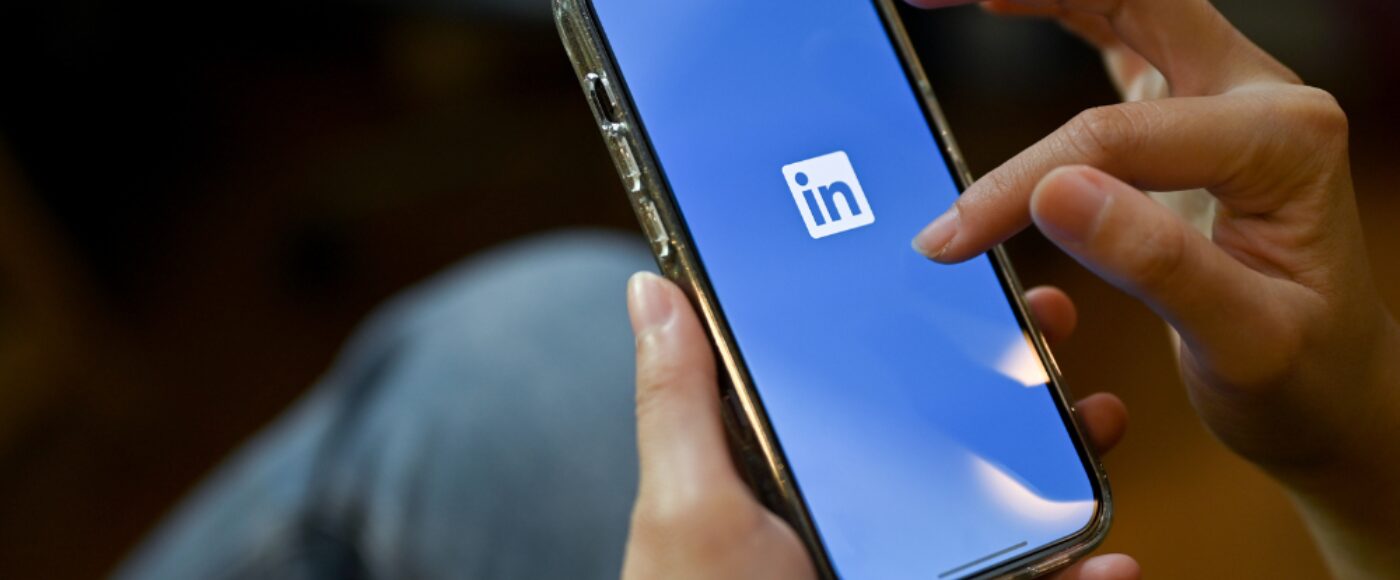 Female using her smartphone with Linked In