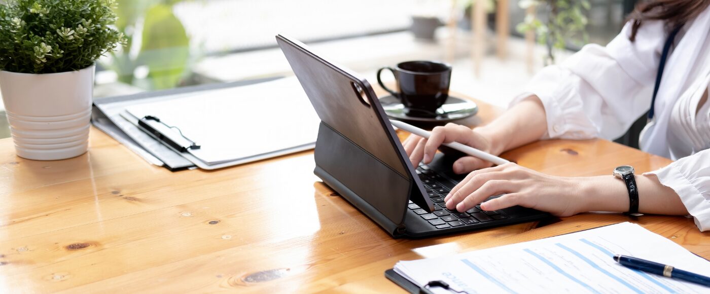 Business person typing on an ipad