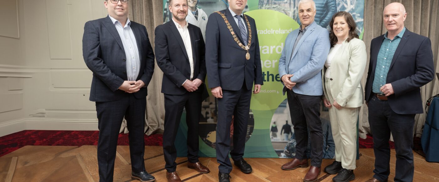 People standing infront of an Inter Trade Ireland banner