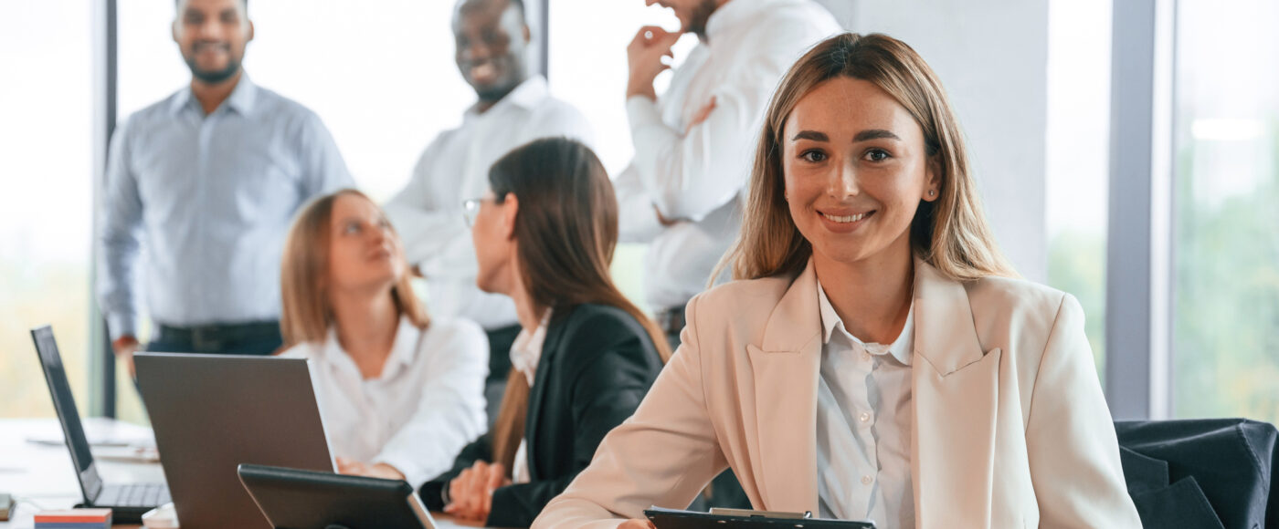 I Stock Raising funding smiling team member in group office