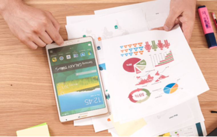 Person looking at a document with infographics