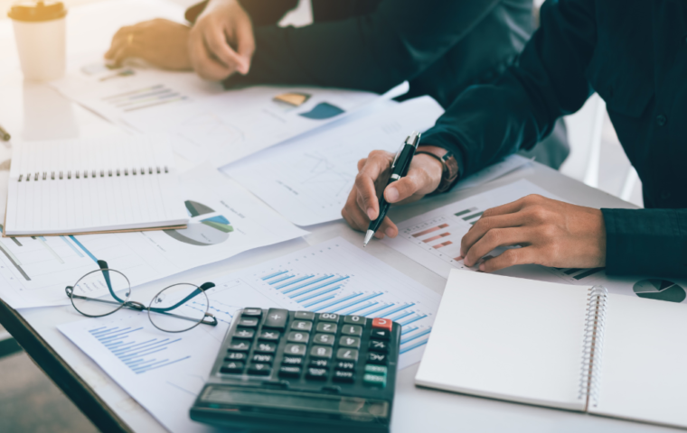 Two Business People calculating charts